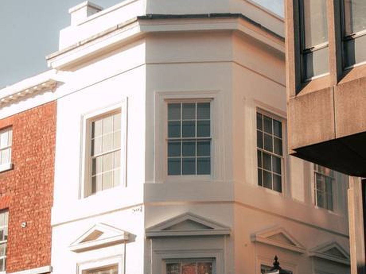 White-rendered period corner house with a bay &mdash; older solid-walled houses need a render that can move and breathe with the wall