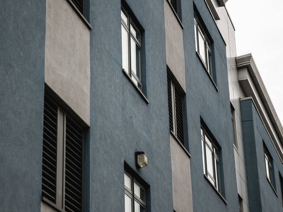 A modern home in a bold anthracite render finish, at the dark end of the palette