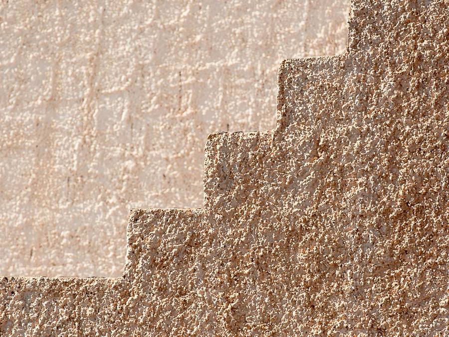 Close-up of a through-coloured scraped K-Rend-style render texture on a UK home